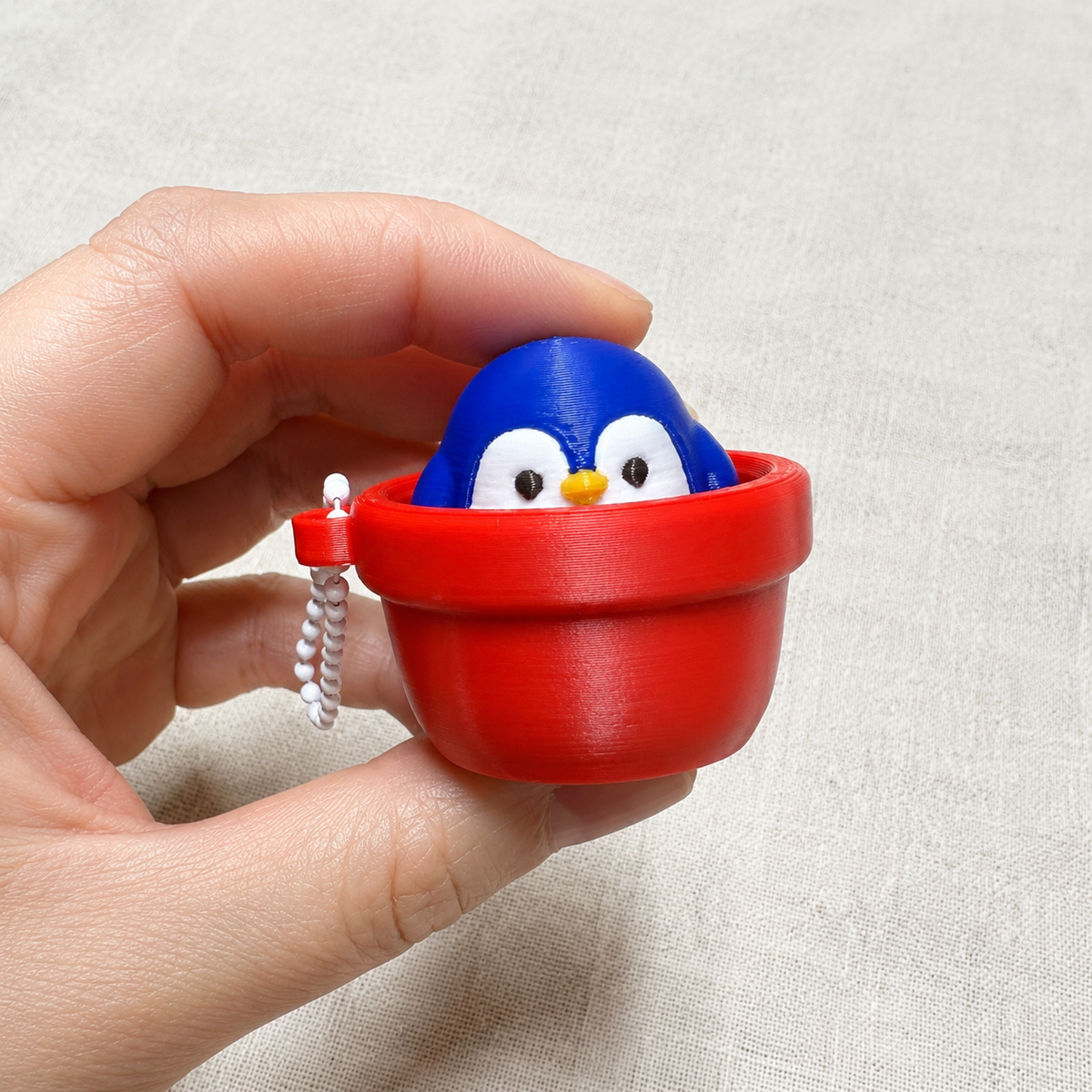 Clicker Pingüino Macetero 18chero